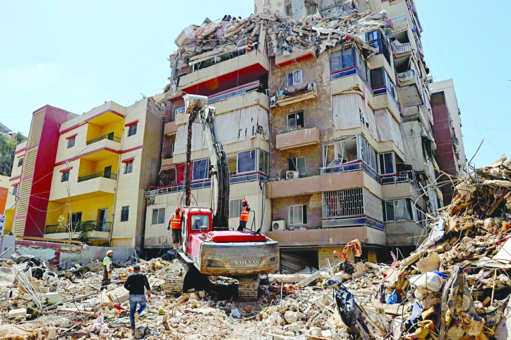 First responders inspect the rubble of a collapsed building following an Israeli airstrike a day earlier in Beirut’s southern suburb of Haret Hreik. - AFP   
