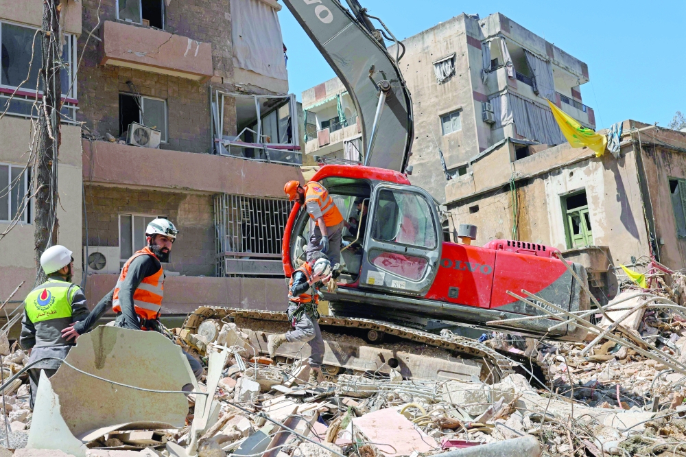 First responders inspect the rubble of a collapsed building following an Israeli airstrike the day earlier in Beirut’s southern suburb of Haret Hreik on on Thursday. - AFP