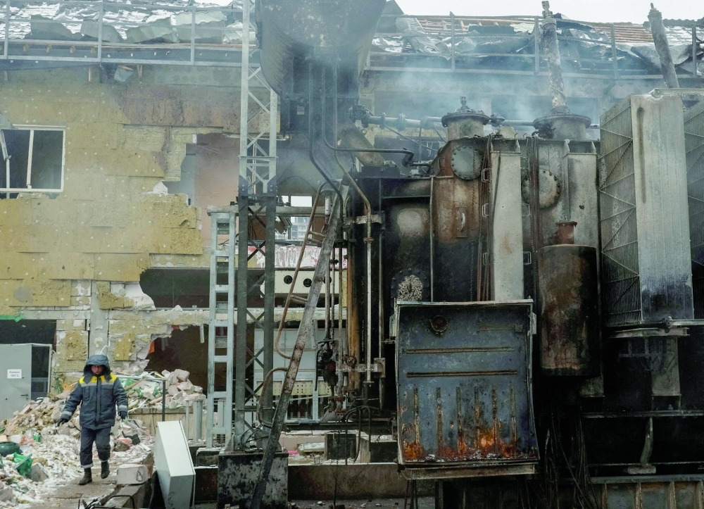 An energy worker walks at a damaged power substation in Odesa, Ukraine. — Reuters