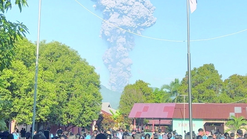 People watch as smoke rises after the eruption of Mount Dukono in North Halmahera Regency, North Maluku, Indonesia. — Reuters