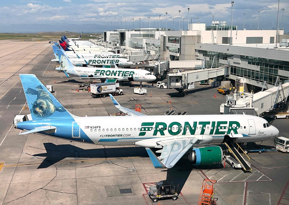 Frontier Airlines planes are parked at gates in Denver International Airport (DEN) in Denver, Colorado.