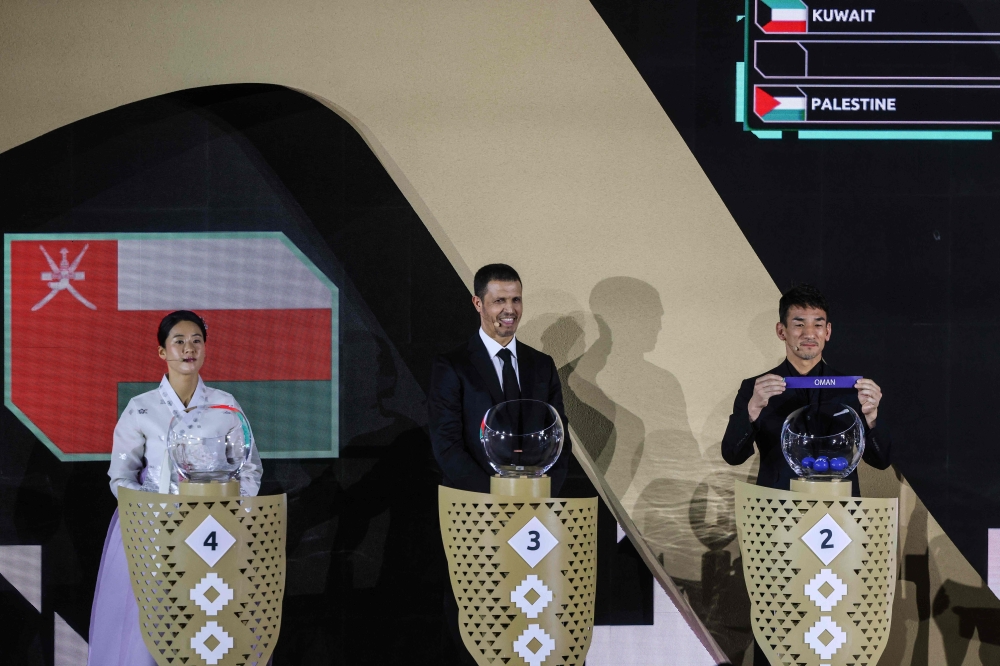 Japanese football icon and two-time AFC Asian Player of the Year Hidetoshi Nakata shows the paper slip of Oman during the final draw of the 2027 AFC Asian Cup 