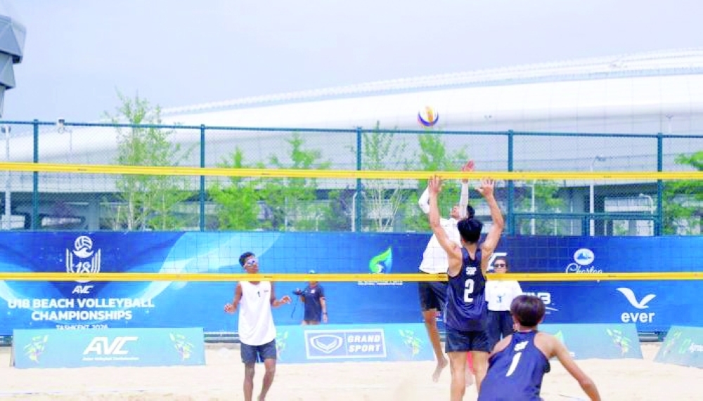The Omani duo battles at the net during Asian U-18 beach volleyball action.