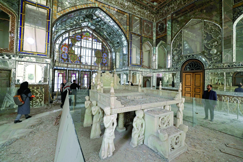 Visitors walk through the damaged interiors of the historic Golestan Palace in Tehran. — AFP