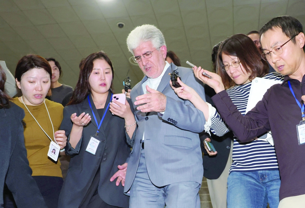 Iranian ambassador to South Korea Saeed Koozechi (C) leaves the Foreign Ministry in Seoul. — AFP