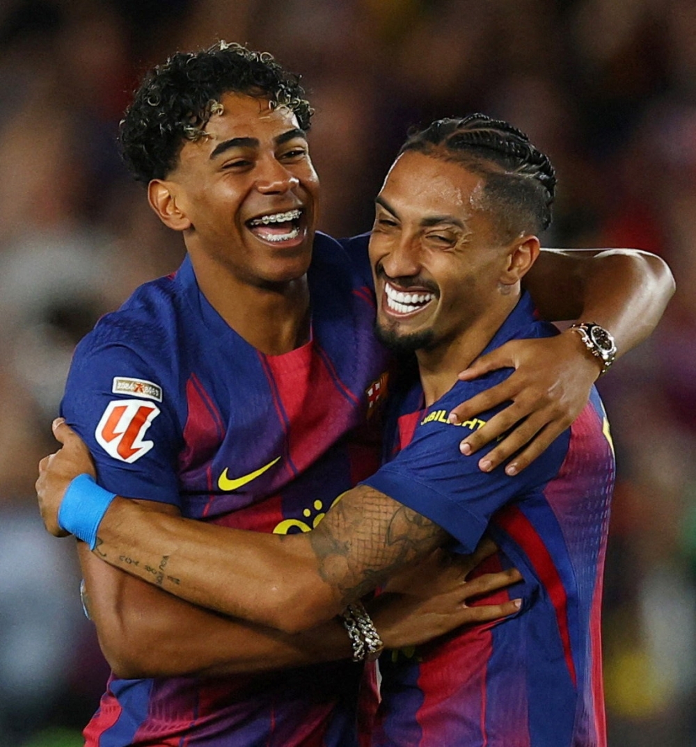  
FC Barcelona's Lamine Yamal and Raphinha celebrate after winning the LaLiga  