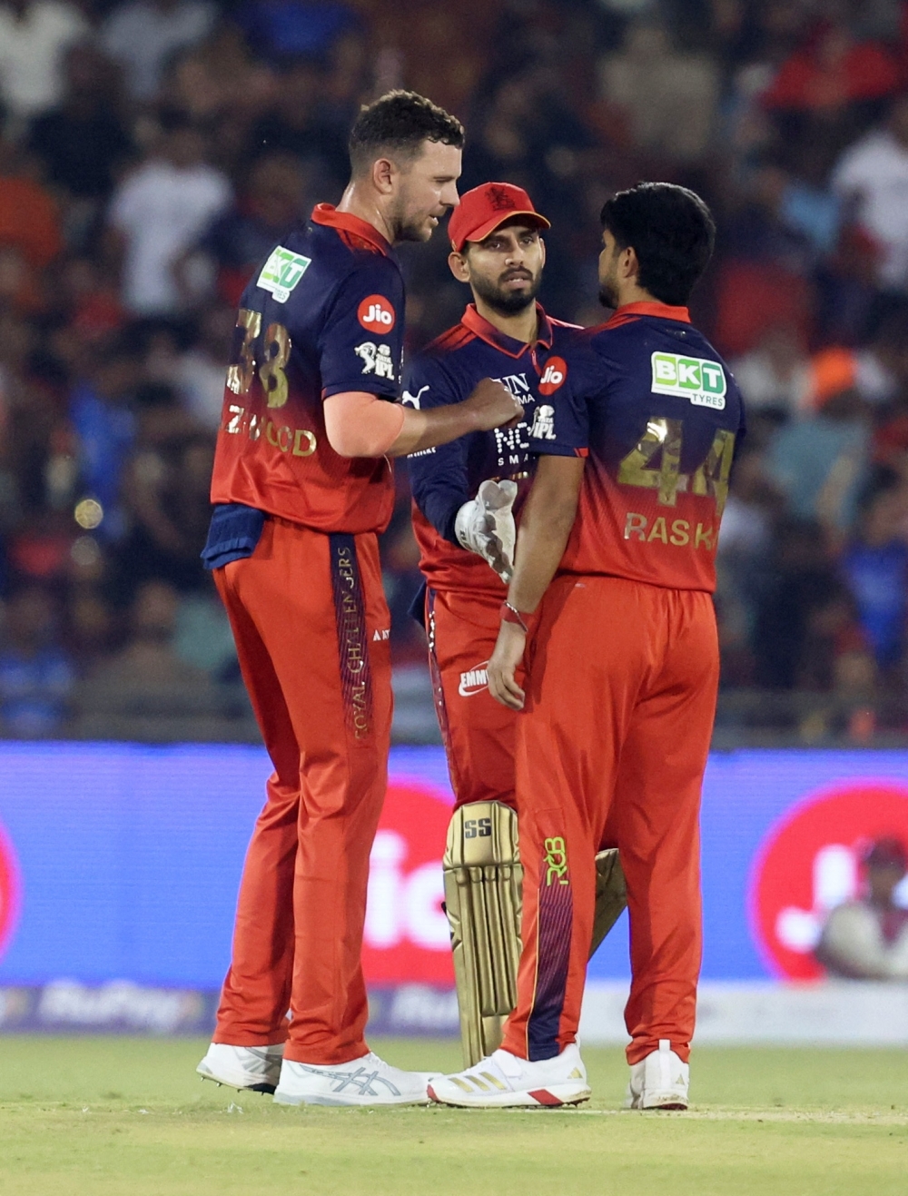  
Royal Challengers Bengaluru's Rasikh Dar celebrates the wicket of Mumbai Indians' Naman Dhir with Josh Hazlewood and Jitesh Sharma  