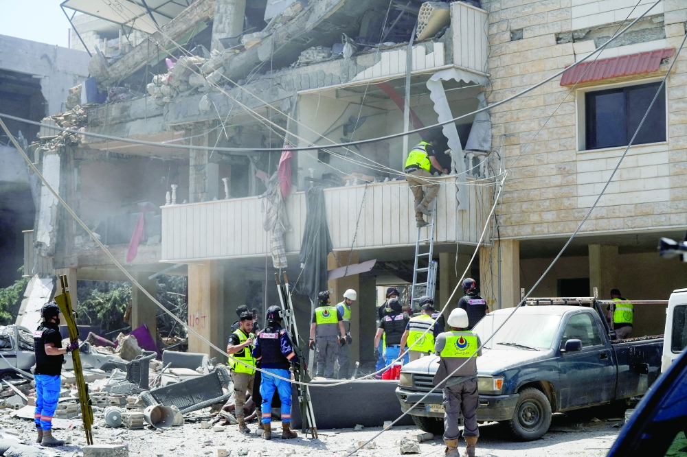Rescuers work at the site of an Israeli strike in Kfar Jouz, Lebanon. — Reuters