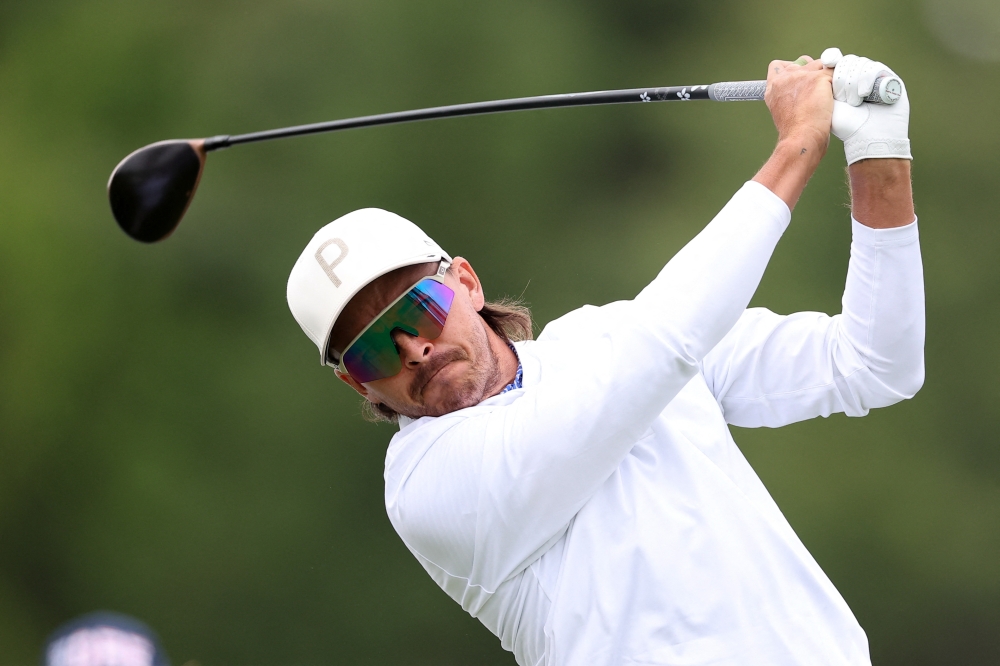  Rickie Fowler plays a tee shot on hole 11 during a practice round of the PGA Championship golf tournament at Aronimink Golf Club 