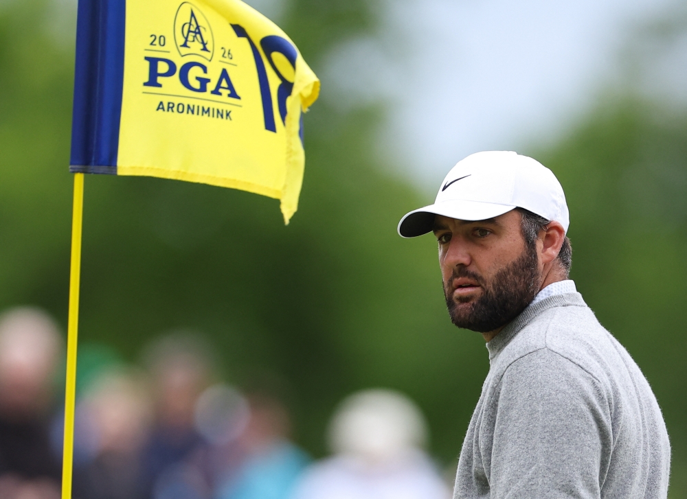 Scottie Scheffler on the the eighteenth green during a practice round of the PGA Championship golf tournament at Aronimink Golf Club 