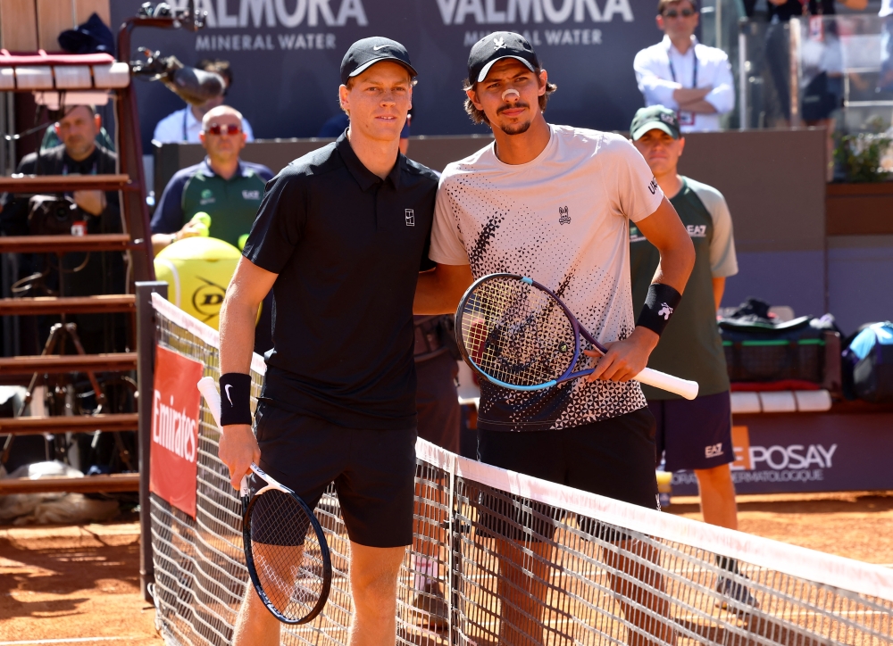  
Italy's Jannik Sinner and Australia's Alexei Popyrin take a photograph before their third round match 