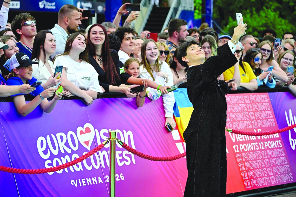 Austrian singer Johannes Pietsch, aka JJ poses on the turquoise carpet for the opening ceremony of the Eurovision Song Contest 2026 at the City Hall Square in Vienna, Austria on May 10, 2026. The event is the official starting point of Eurovision week in Vienna. The city will host the two semi-finals on May 12 and May 14 and the final on May 16, 2026. _ AFP