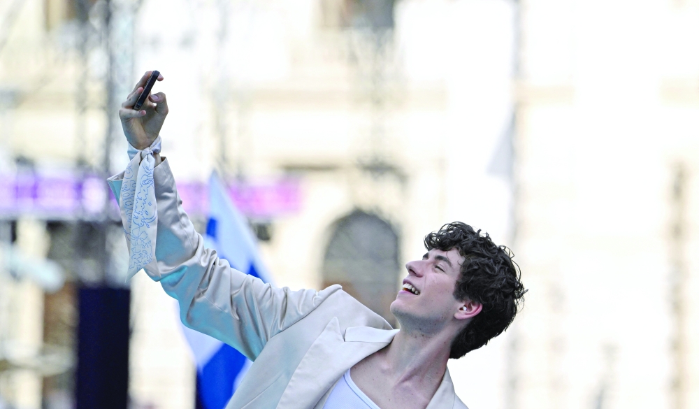 Czech singer Daniel Zizka, representing Czech Republic with the song 'Crossroads', poses for photographers on the turquoise carpet for the opening ceremony of the Eurovision Song Contest 2026 at the City Hall Square in Vienna, Austria on May 10, 2026. The event is the official starting point of Eurovision week in Vienna. The city will host the two semi-finals on May 12 and May 14 and the final on May 16, 2026. _ AFP