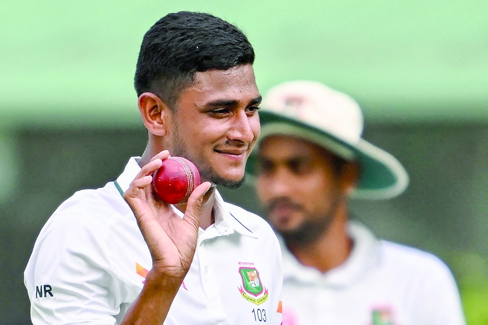 Bangladesh's Nahid Rana acknowledges the crowd after taking a five-wicket haul after his team's win at the end of the first Test cricket match against Pakistan at the Sher-e-Bangla National Stadium in Mirpur on May 12, 2026.  (Photo by Munir UZ ZAMAN / AFP)