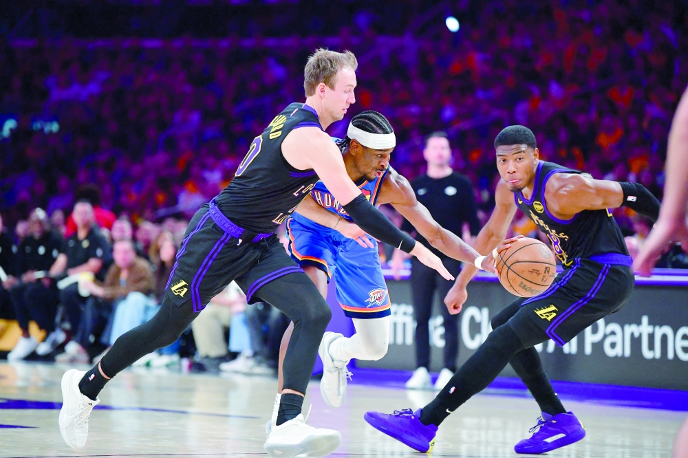 Los Angeles Lakers' Luke Kennard (10) and Rui Hachimura (28) move in for the ball against Oklahoma City Thunder's Shai Gilgeous-Alexander (2) in game four of the second round of the 2026 NBA Playoffs at Crypto.com Arena. — Imagn Images