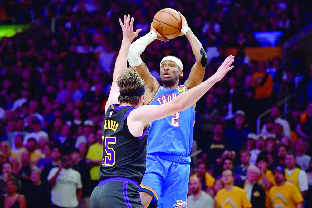 Oklahoma City Thunder's Shai Gilgeous-Alexander (2) passes the ball against Los Angeles Lakers' Austin Reaves (15) in game four of the second round of the 2026 NBA Playoffs at Crypto.com Arena. — Imagn Images