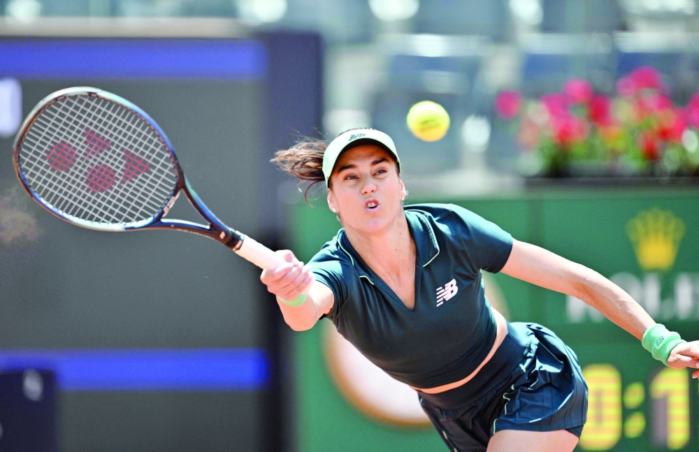 Romania's Sorana Cirstea hits a return to Latvia's Jelena Ostapenko during the ATP Rome Open tennis tournament at Foro Italico in Rome on May 12, 2026.  (Photo by Tiziana FABI / AFP)
