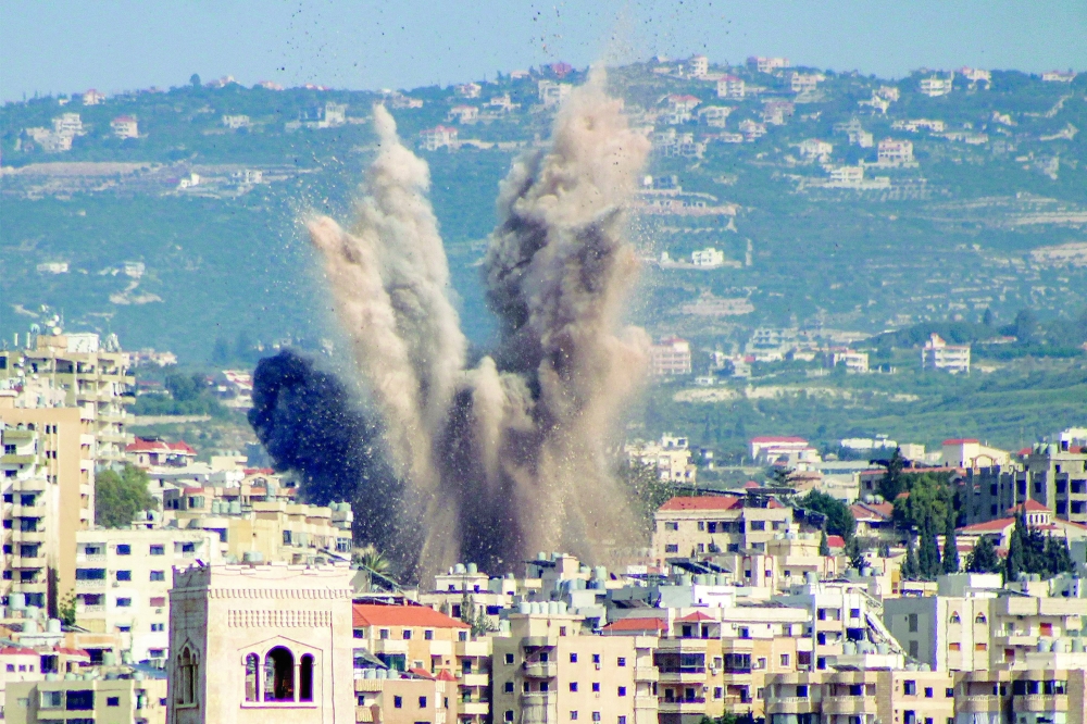 An explosion erupts in the area of Al Housh following Israeli bombardment as seen from Tyre in southern Lebanon. — AFP