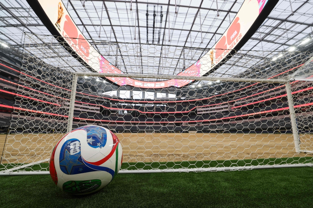 A giant ball is displayed behind a goal as an expanded pitch surface area, which required the removal of corner seating and a raised custom field platform, awaits the installation of grass  