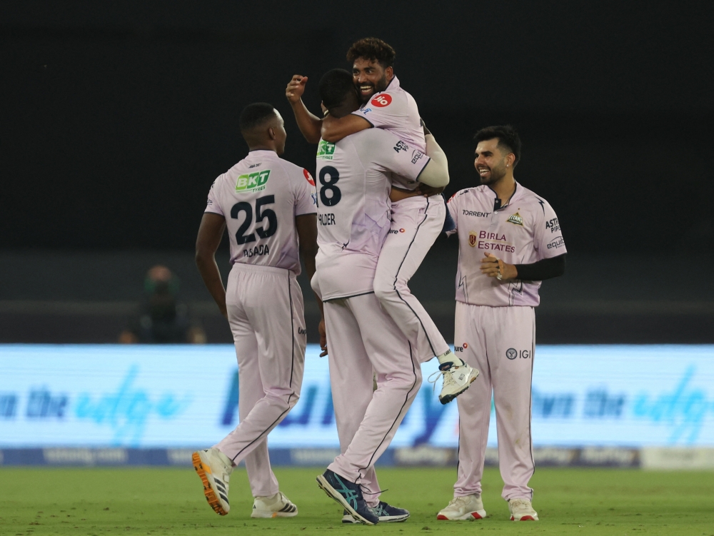  
Gujarat Titans' Jason Holder celebrates with Kagiso Rabada and teammates taking the wicket of Sunrisers Hyderabad's Heinrich Klaasen  