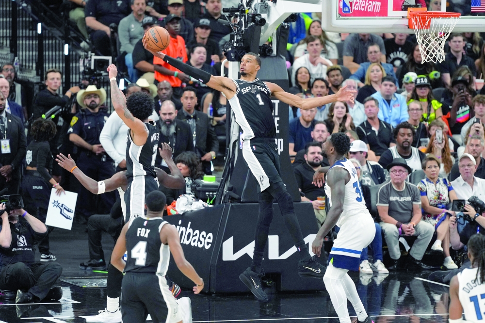 San Antonio Spurs' Victor Wembanyama (1) reaches for a rebound over Minnesota Timberwolves' Julius Randle (30) during game five of the second round of the 2026 NBA Playoffs at Frost Bank Center. — Imagn Images