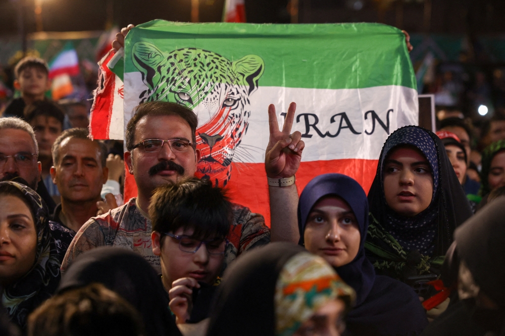 A man gestures as people gather at a farewell ceremony for Iran's national soccer team ahead of their departure to the 2026 World Cup 