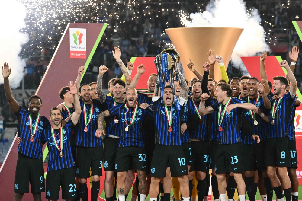  Inter Milan's Argentine forward #10 Lautaro Martinez lifts the trophy of the Italian Cup (Coppa Italia) and celebrates with teammates