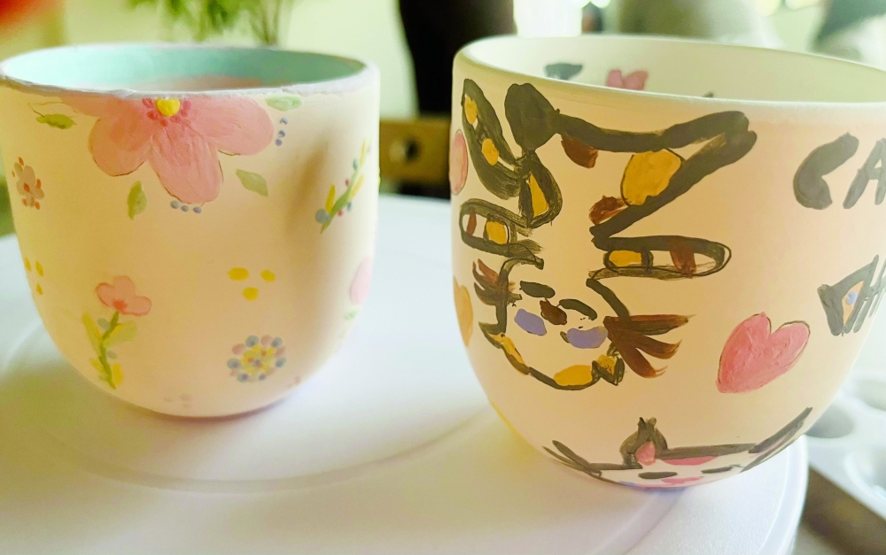 Her painted ceramic mug looks much better than mine.