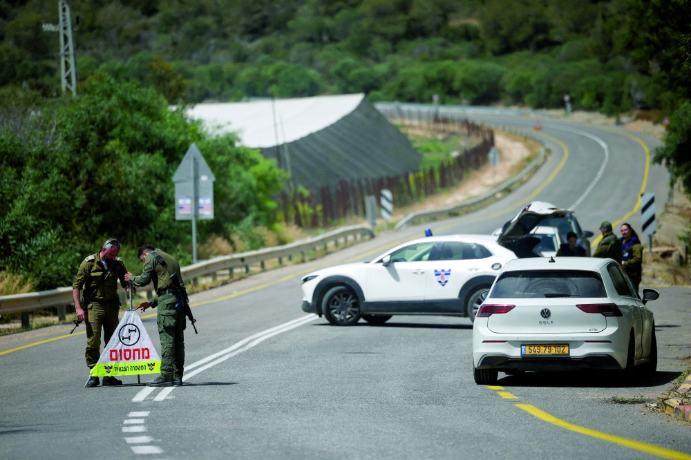Soldiers set up a roadblock on the road leading to the tourist site in northern Israel. — Reuters