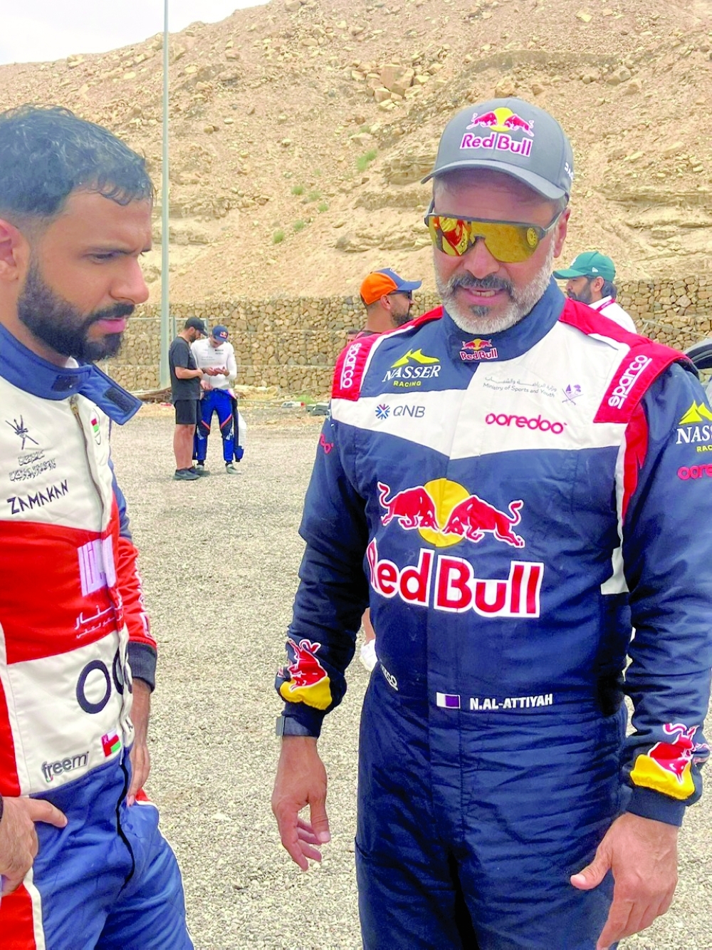 Abdullah al Rawahi and Nasser Saleh al Attiyah interact during a break.