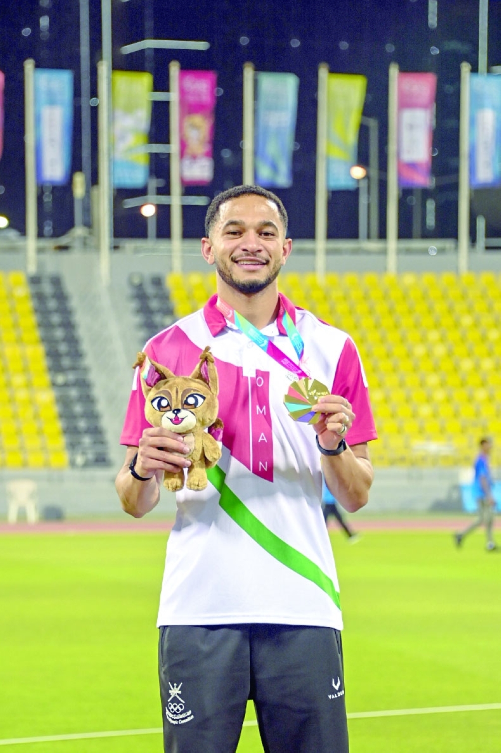 Ali al Balushi poses with his 100 metres gold.