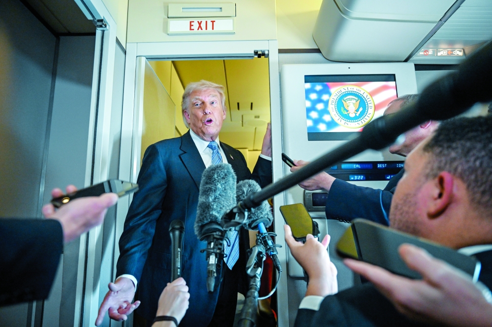 President Donald Trump speaks to reporters aboard Air Force One. — NYT 