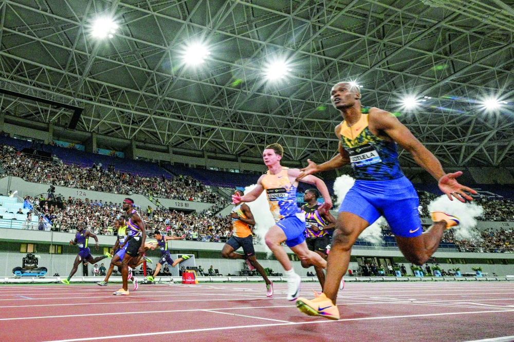 South Africa's Gift Leotlela (R) wins the men's 100m event during the Shanghai/Keqiao Diamond League athletics meeting in Keqiao, Shaoxing in China's eastern Zhejiang province on May 16, 2026. (Photo by Hector RETAMAL / AFP)
