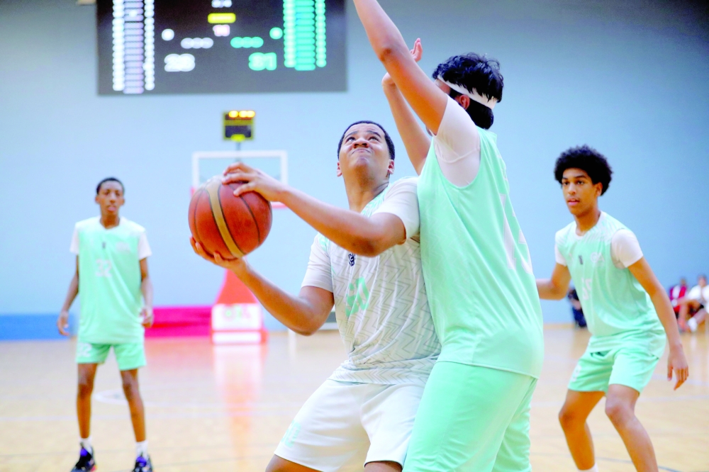 A player drives to the basket during a match in the Athletes Preparation Centres Basketball League. — Ammar al Musafir