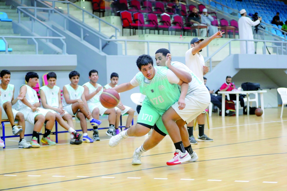 Action from the latest round of the Athletes Preparation Centres Basketball League in Bausher. — Ammar al Musafir