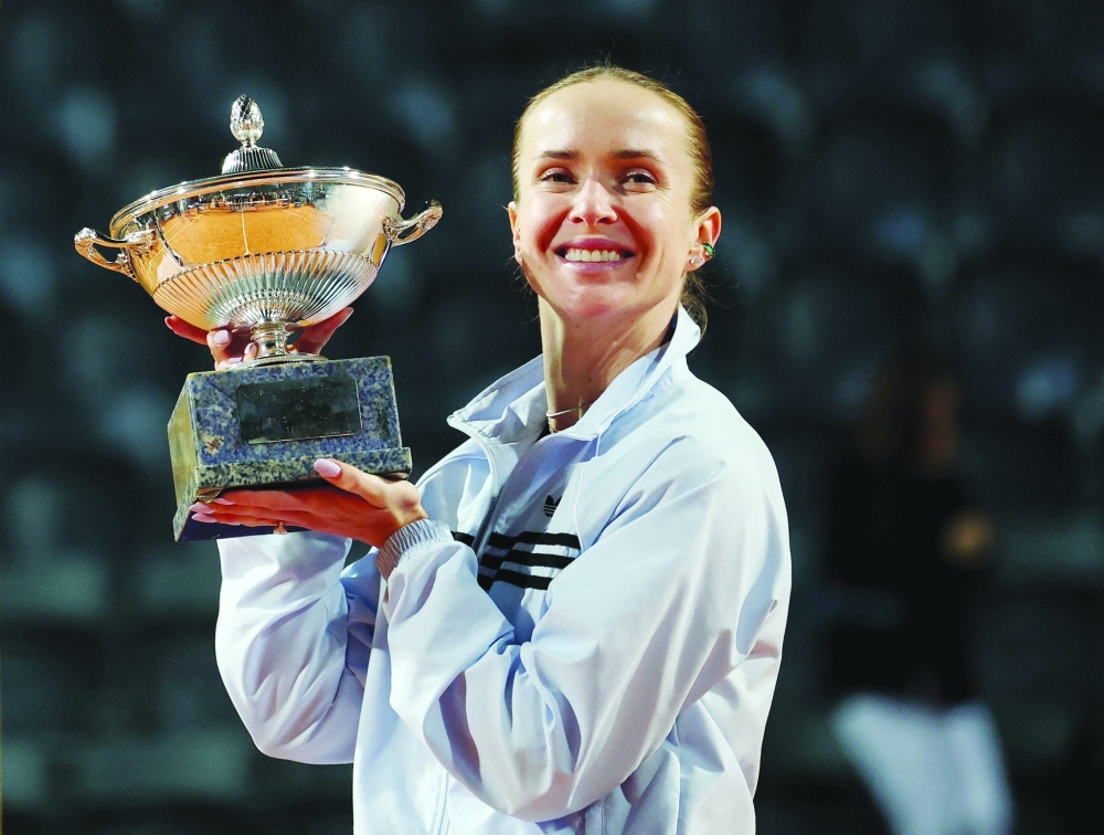 Ukraine's Elina Svitolina celebrates with the trophy after winning the women's final match against Coco Gauff. — Reuters