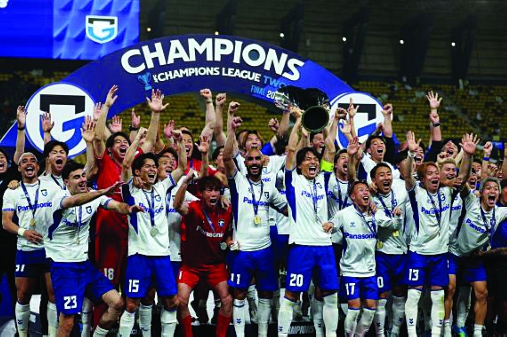 Gamba Osaka players celebrate with the trophy after their victory over Al-Nassr of Saudi Arabia in the AFC final.