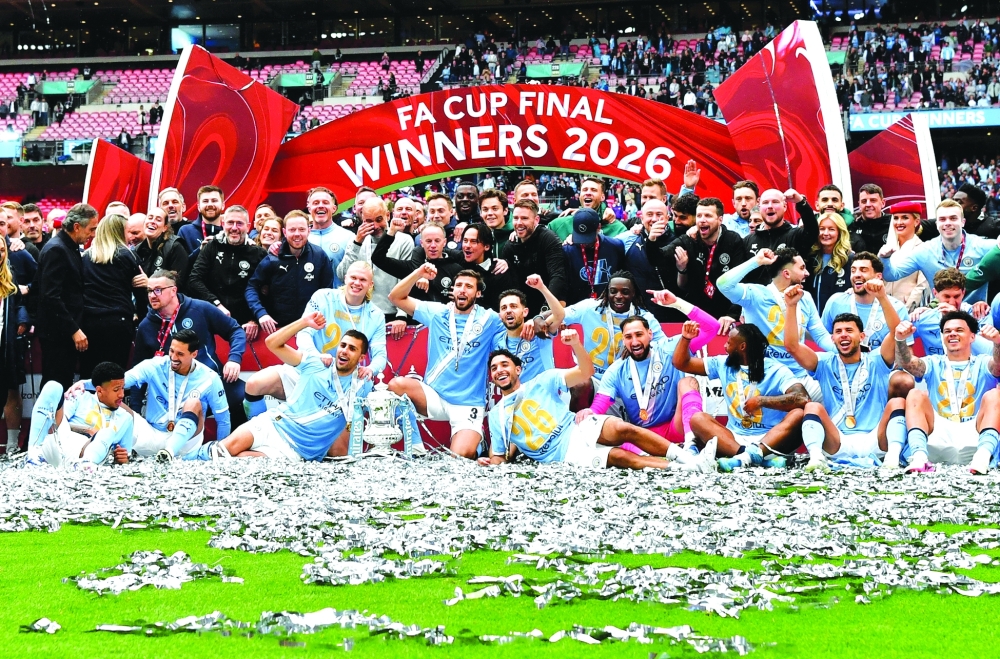Manchester City players celebrate with the FA Cup trophy. — Reuters