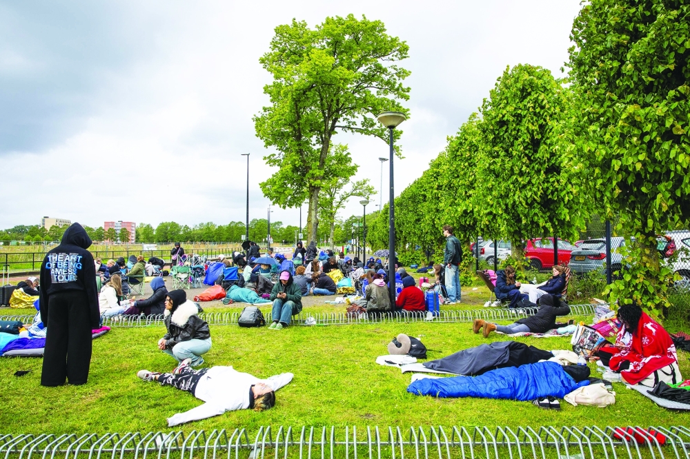 Fans of British singer Harry Styles await outside the Johan Cruijff ArenA, the day before he begins his ten-day concert series and his world tour Together, Together Tour in Amsterdam on May 15, 2026. Ten years after One Direction split up, British singer Harry Styles, who is setting off on tour this May 16, 2026, in Amsterdam with his fourth album, has established himself as one of the world’s biggest pop stars, thanks to his stage presence and his embodiment of a new form of masculinity. - Netherlands OUT
