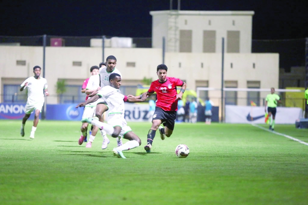 Oman U20 players battle for possession during their friendly match against Egypt U20 in Cairo.