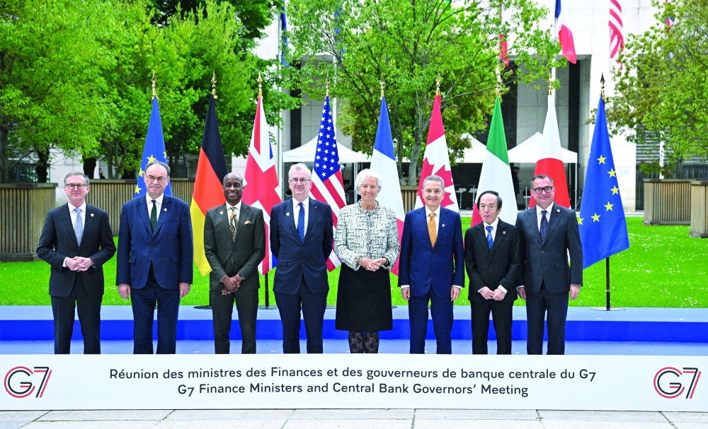 Delegates pose for a family photograph at the French Ministry of Economy and Finance in Paris. — AFP