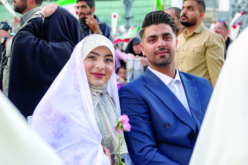 A bride and groom attend a public mass wedding ceremony at Imam Hossein Square in Tehran on Tuesday. - AFP