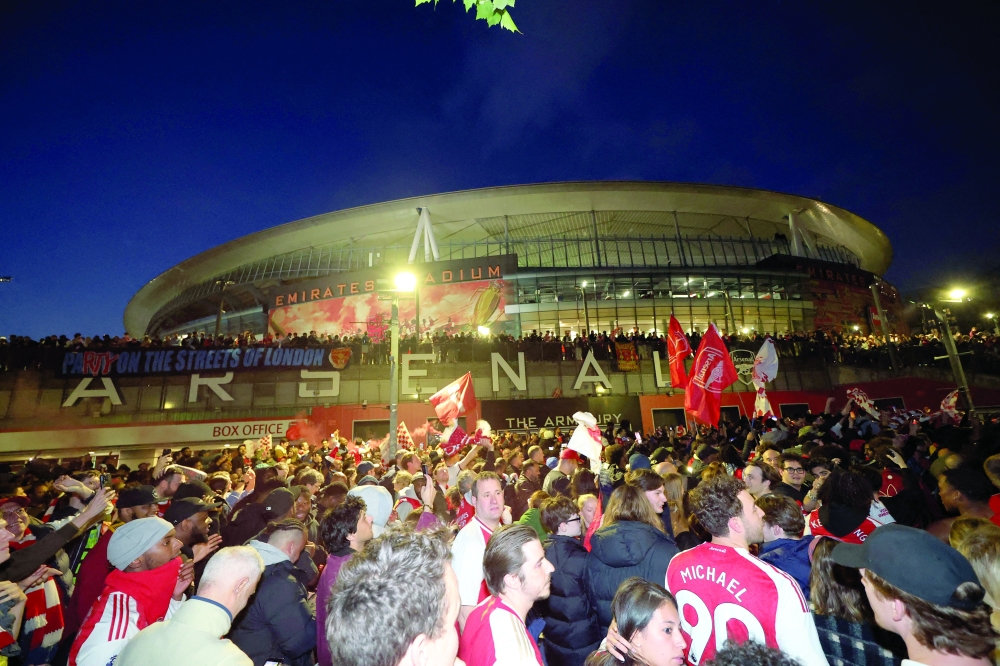Arsenal fans celebrate outside the Emirates stadium as Arsenal win the Premier League Action Images via Reuters/Andrew Boyers