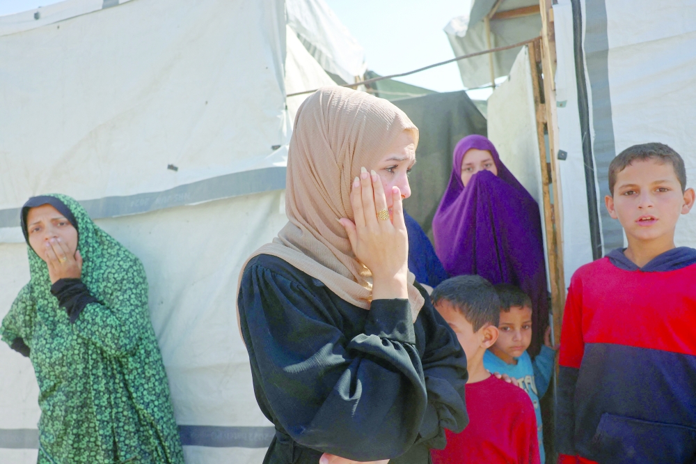 Displaced Palestinians react near the site of an Israeli strike that targeted a food distribution tent in the Mawasi area of Khan Yunis, in the southern Gaza Strip. — AFP