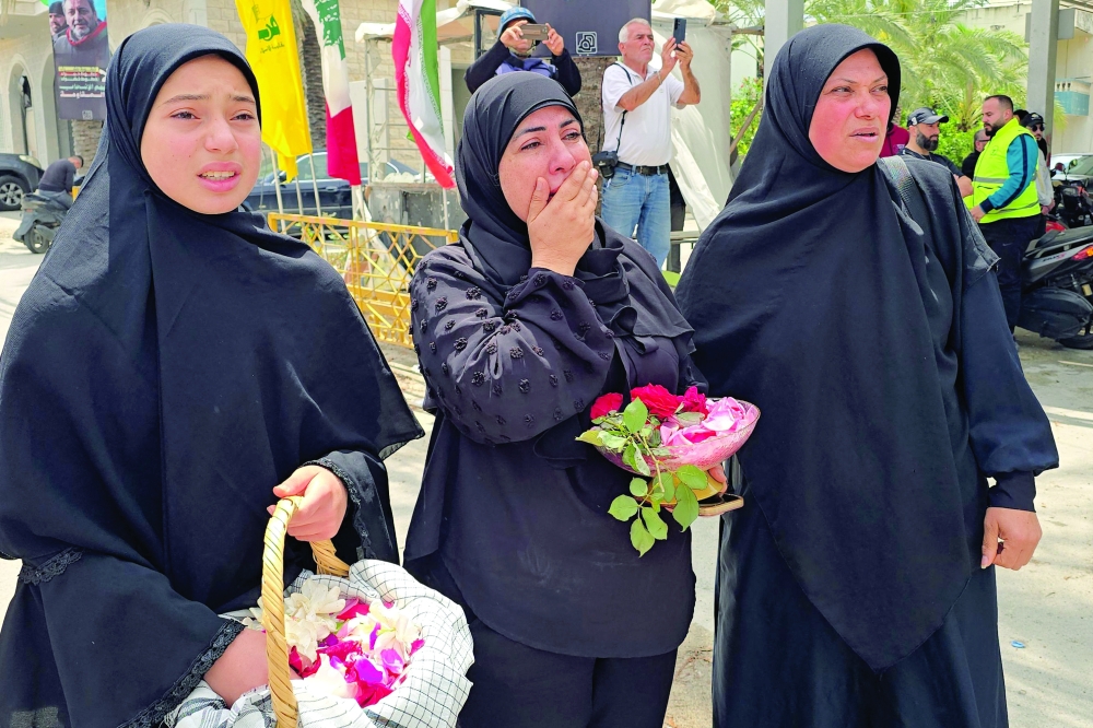 Relatives attend the funeral of victims killed in the Israeli strike on the southern village of Deïr Qanoun en Nahr in their hometown of the Tyre area of south Lebanon. — AFP