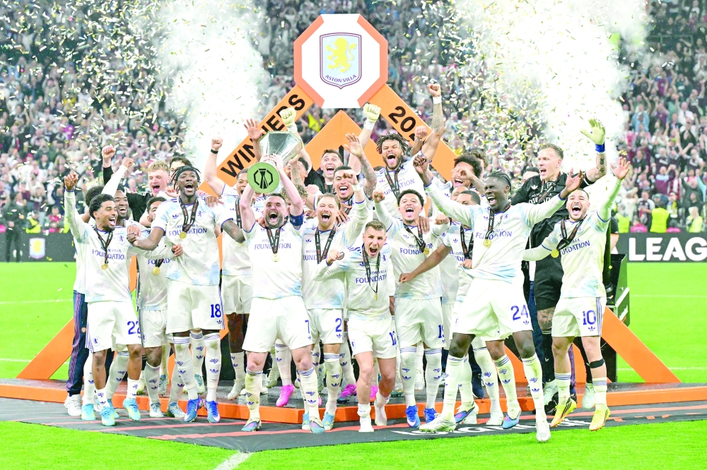 Aston Villa's Scottish midfielder #07 John McGinn and his teammates celebrate with the trophy after winning the UEFA Europa League final football match between SC Freiburg and Aston Villa at Besiktas Park in Istanbul on May 20, 2026. (Photo by Stefano RELLANDINI / AFP)
