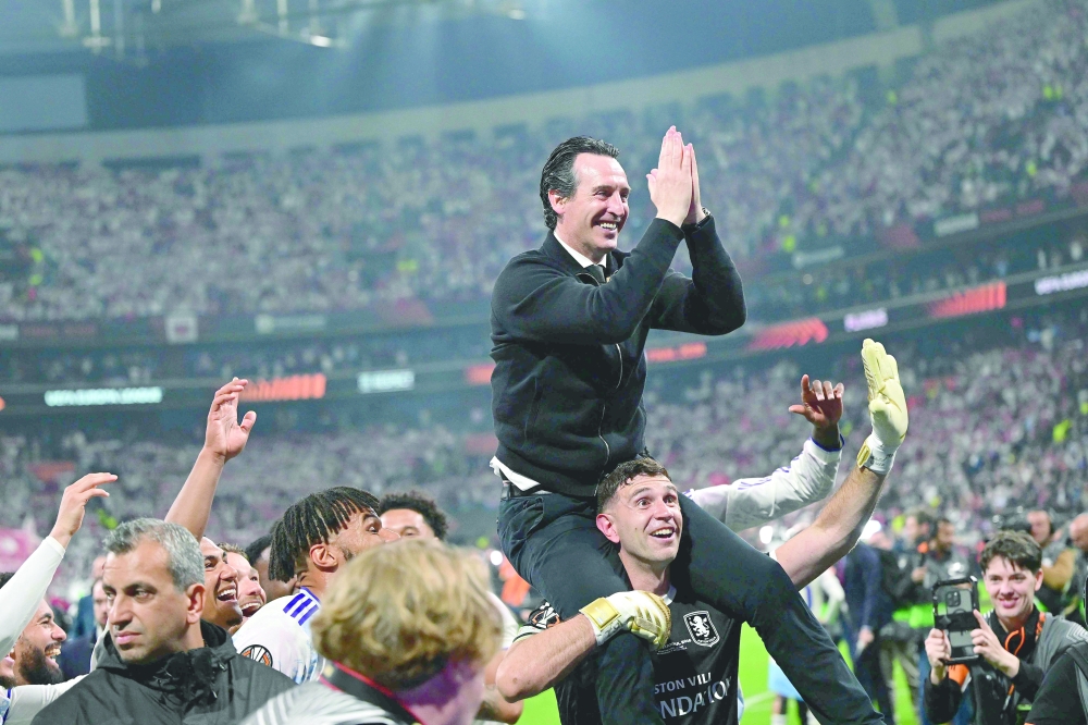 Aston Villa's Spanish manager Unai Emery celebrates with his players after winning the UEFA Europa League final football match between SC Freiburg and Aston Villa at Besiktas Park in Istanbul on May 20, 2026. (Photo by YASIN AKGUL / AFP)
