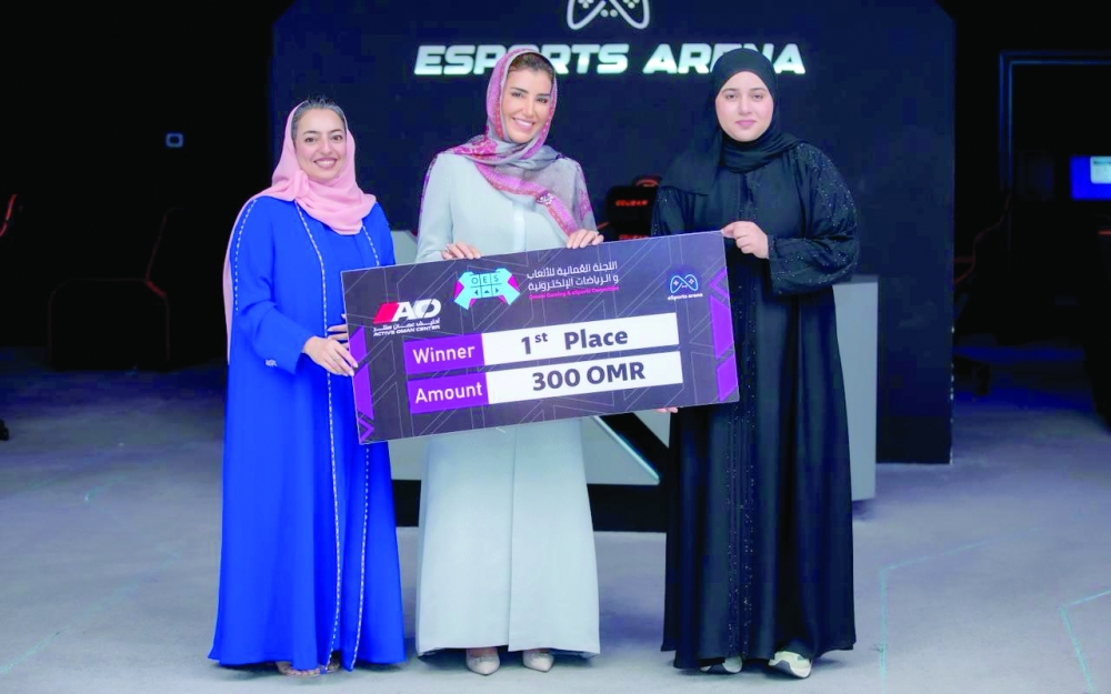 Shahad al Qaidhi receives the first-place award after being crowned champion of the FC26 Girls Championship at Active Oman Centre.