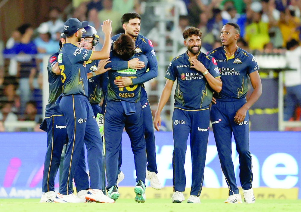Gujarat Titans' Mohammed Siraj  celebrates with teammates after taking the wicket of Chennai Super Kings' Shivam Dube. — Reuters 