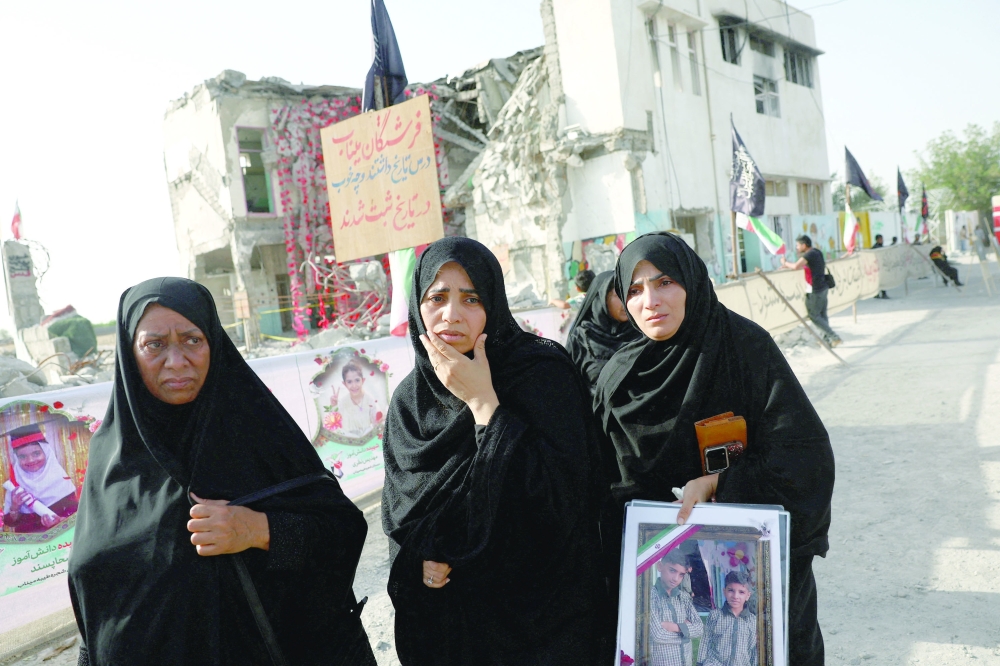 Raheleh, an Iranian woman who lost two of her children in Minab school strike on February 28, reacts at Minab school in Minab, Iran. — Reuters
